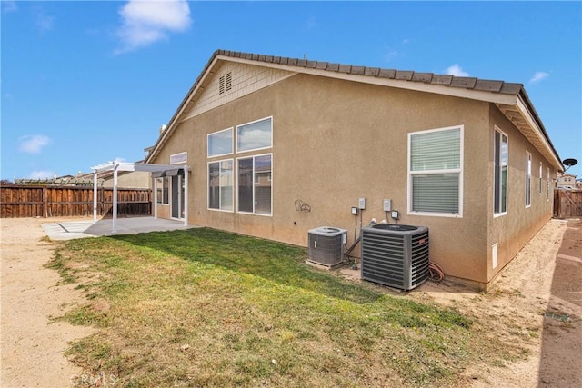 13204 Monrovia St, Hesperia, CA 92344 - back of property with central AC unit, a fenced backyard, a patio, and a yard