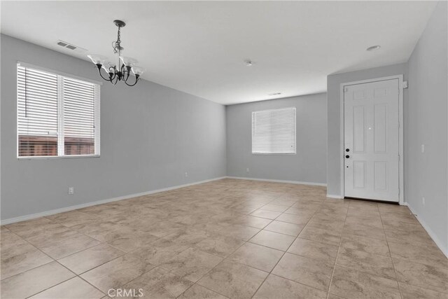 13204 Monrovia St, Hesperia, CA 92344 - spare room with light tile patterned floors, baseboards, a chandelier, and visible vents