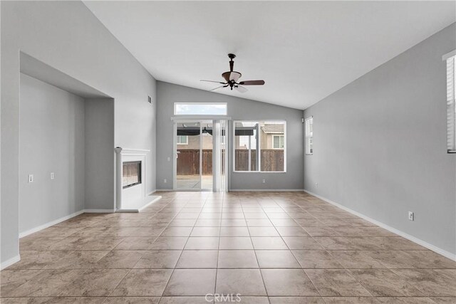 13204 Monrovia St, Hesperia, CA 92344 - unfurnished living room featuring vaulted ceiling, baseboards, tile patterned floors, ceiling fan, and a glass covered fireplace