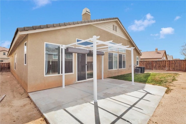 13204 Monrovia St, Hesperia, CA 92344 - rear view of property featuring stucco siding, a pergola, a fenced backyard, a patio, and central AC unit