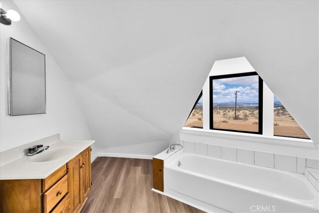 951 N Kuna Ave, Landers, CA 92285 - bathroom featuring wood finished floors, lofted ceiling, a bath, vanity, and baseboards