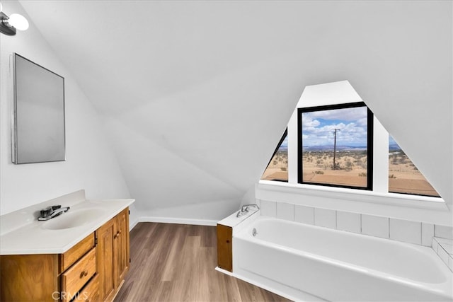 951 N Kuna Ave, Landers, CA 92285 - bathroom with a bath, wood finished floors, vanity, and lofted ceiling