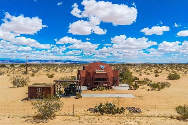 951 N Kuna Ave, Landers, CA 92285 - view of front of home with fence, view of desert, and a view of rural / pastoral area