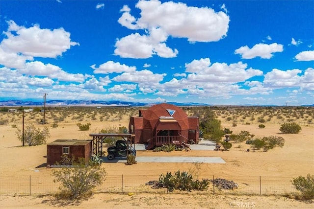 951 N Kuna Ave, Landers, CA 92285 - view of front of house featuring a desert view, a rural view, and a carport