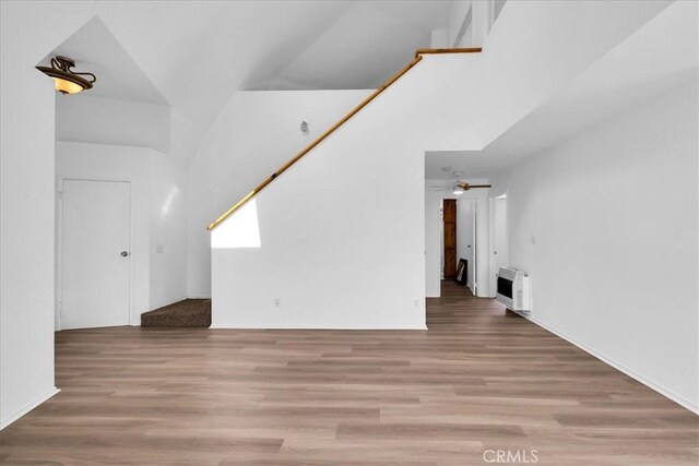 951 N Kuna Ave, Landers, CA 92285 - unfurnished living room with wood finished floors, a ceiling fan, and heating unit