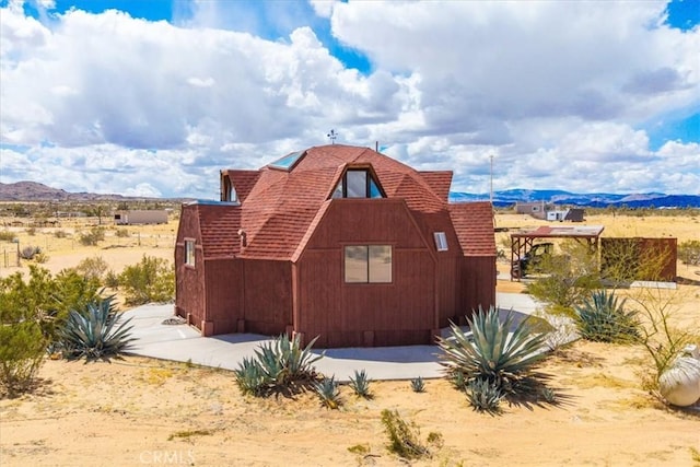 951 N Kuna Ave, Landers, CA 92285 - view of home's exterior with a mountain view and a shingled roof