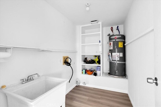 951 N Kuna Ave, Landers, CA 92285 - laundry room with electric water heater and wood finished floors