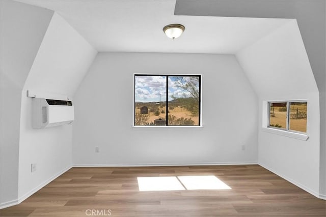 951 N Kuna Ave, Landers, CA 92285 - additional living space featuring healthy amount of natural light, wood finished floors, vaulted ceiling, and an AC wall unit