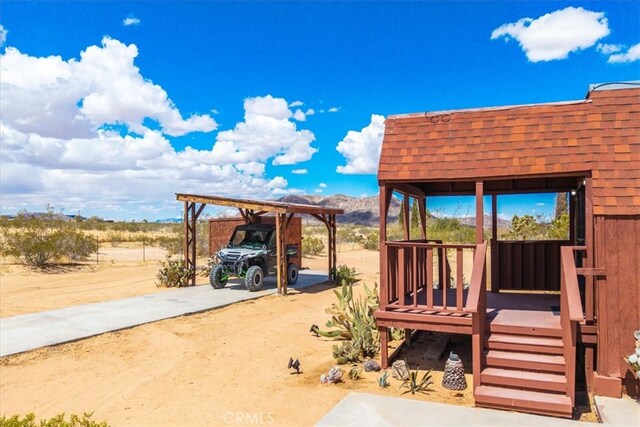 951 N Kuna Ave, Landers, CA 92285 - wooden deck with a detached carport and a mountain view
