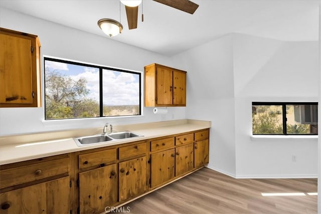 951 N Kuna Ave, Landers, CA 92285 - kitchen featuring brown cabinets, light countertops, ceiling fan, and light wood-style floors