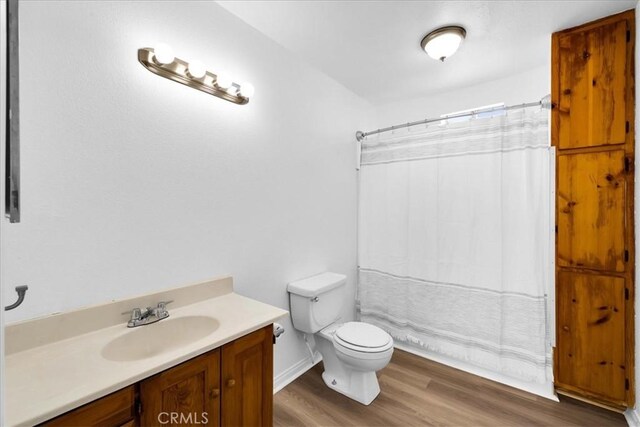 951 N Kuna Ave, Landers, CA 92285 - bathroom with toilet, vanity, wood finished floors, and a shower with curtain