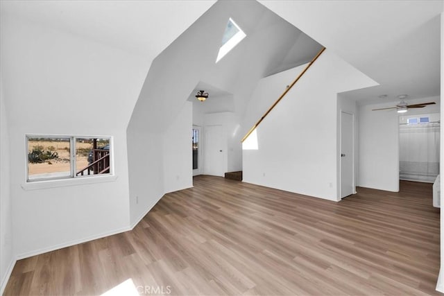 951 N Kuna Ave, Landers, CA 92285 - unfurnished living room with light wood-style floors, healthy amount of natural light, a ceiling fan, and lofted ceiling