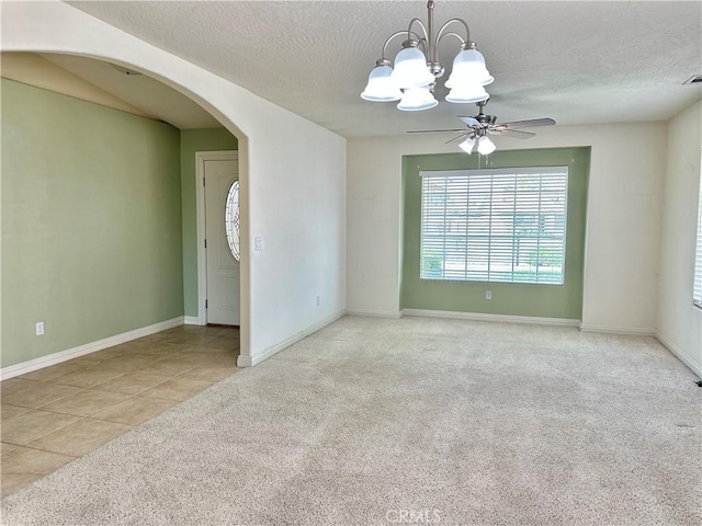 27813 Hummingbird Ln, Helendale, CA 92342 - carpeted empty room with arched walkways, a textured ceiling, baseboards, and ceiling fan with notable chandelier