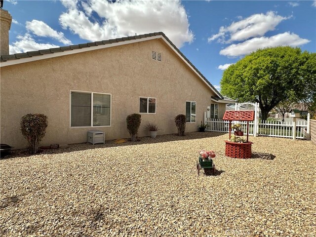27813 Hummingbird Ln, Helendale, CA 92342 - rear view of house with stucco siding and fence