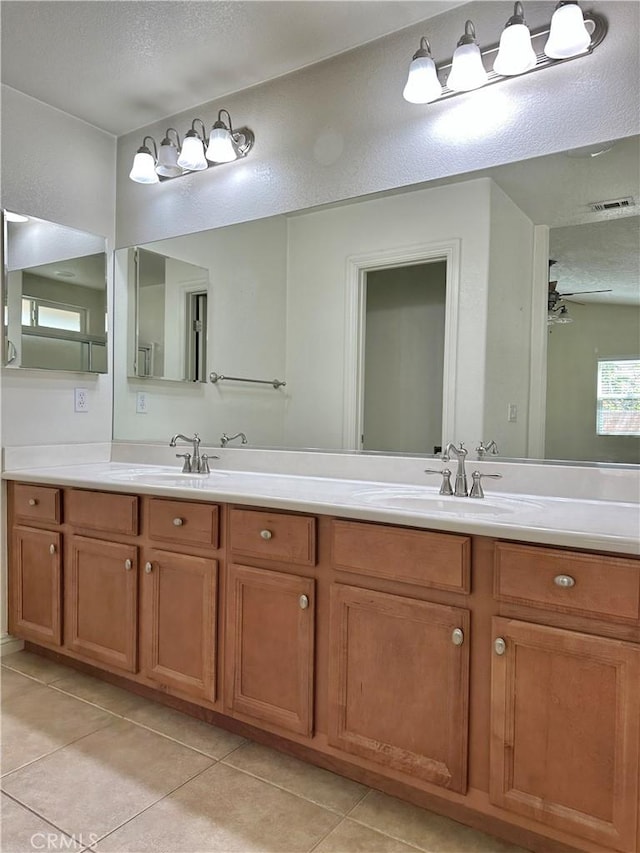 27813 Hummingbird Ln, Helendale, CA 92342 - full bathroom with tile patterned floors, visible vents, double vanity, and a sink