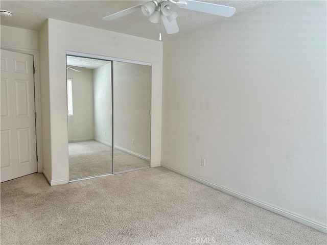 27813 Hummingbird Ln, Helendale, CA 92342 - unfurnished bedroom featuring a closet, carpet floors, a ceiling fan, a textured ceiling, and baseboards