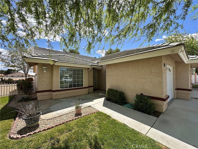 27813 Hummingbird Ln, Helendale, CA 92342 - view of front of home with a tile roof, stucco siding, fence, and a patio area