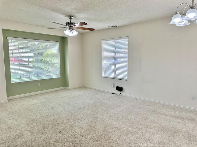 27813 Hummingbird Ln, Helendale, CA 92342 - carpeted empty room with a textured ceiling, visible vents, a healthy amount of sunlight, and ceiling fan with notable chandelier