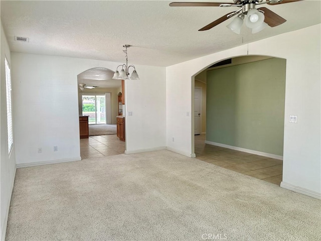 27813 Hummingbird Ln, Helendale, CA 92342 - spare room with a textured ceiling, visible vents, ceiling fan, arched walkways, and light colored carpet