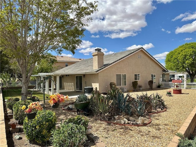 27813 Hummingbird Ln, Helendale, CA 92342 - back of property with fence, a chimney, stucco siding, and a patio
