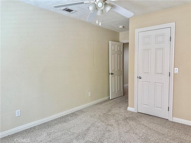27813 Hummingbird Ln, Helendale, CA 92342 - unfurnished bedroom with carpet flooring, a textured ceiling, baseboards, and visible vents