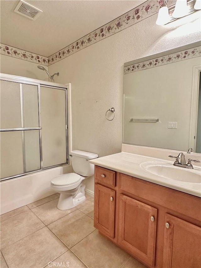 27813 Hummingbird Ln, Helendale, CA 92342 - full bathroom featuring visible vents, toilet, vanity, enclosed tub / shower combo, and tile patterned flooring