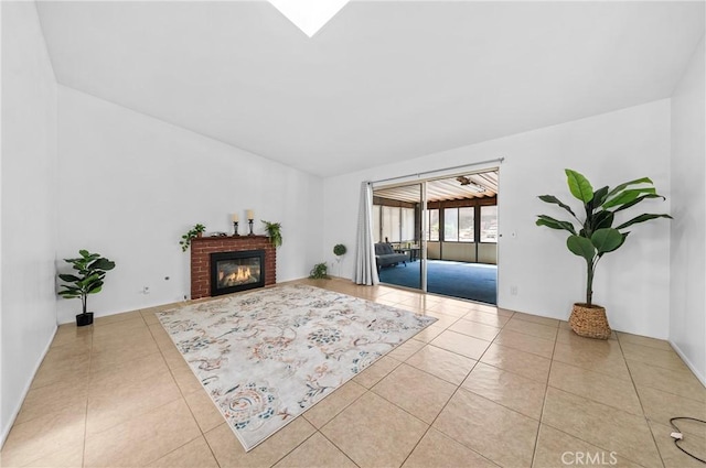 living area with tile patterned floors and a brick fireplace