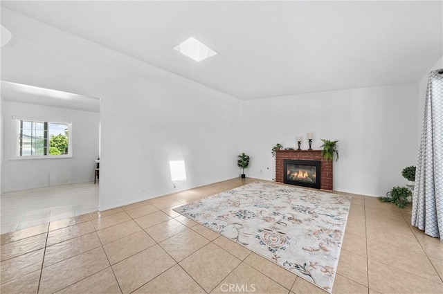 tiled living room with a brick fireplace