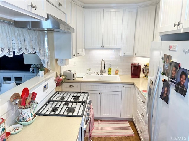 258 17th St, Seal Beach, CA 90740 - kitchen featuring white fridge with ice dispenser, gas stove, a sink, light countertops, and decorative backsplash