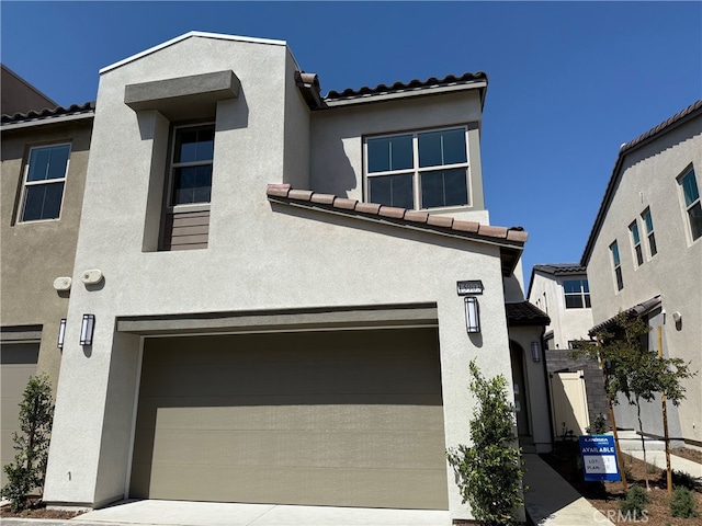 15903 Blue Copper Way, Fontana, CA 92336 - view of front of house with a tiled roof, stucco siding, and a garage