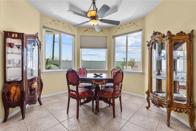 1403 Sonora St, San Bernardino, CA 92404 - dining area featuring a ceiling fan, light tile patterned floors, a tray ceiling, and baseboards