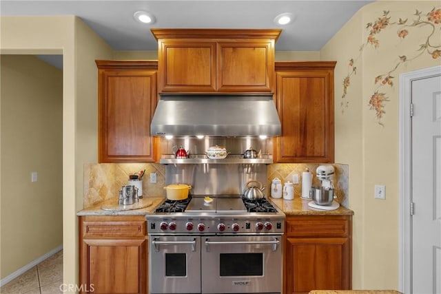 1403 Sonora St, San Bernardino, CA 92404 - kitchen with backsplash, double oven range, range hood, and brown cabinets