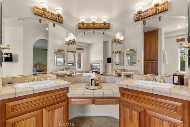 1403 Sonora St, San Bernardino, CA 92404 - ensuite bathroom featuring connected bathroom, tile patterned floors, double vanity, and a sink