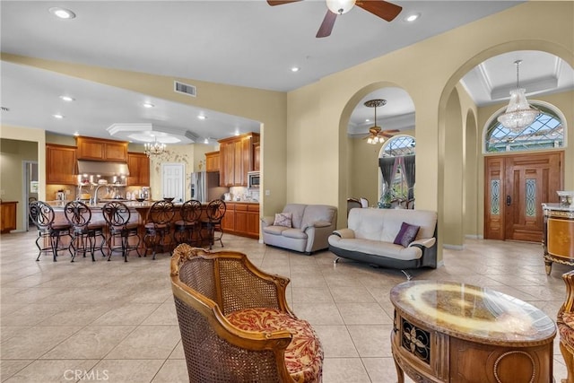 1403 Sonora St, San Bernardino, CA 92404 - living area with light tile patterned floors, recessed lighting, ceiling fan with notable chandelier, and visible vents
