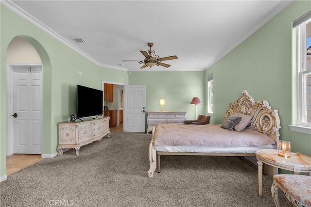 1403 Sonora St, San Bernardino, CA 92404 - carpeted bedroom featuring arched walkways, crown molding, baseboards, and visible vents