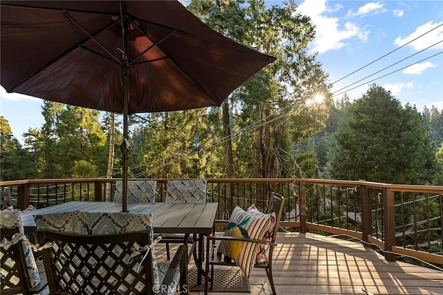 wooden deck featuring outdoor dining area