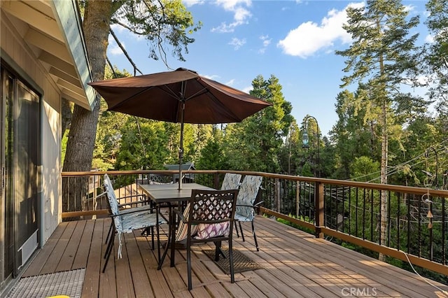 wooden deck featuring outdoor dining area