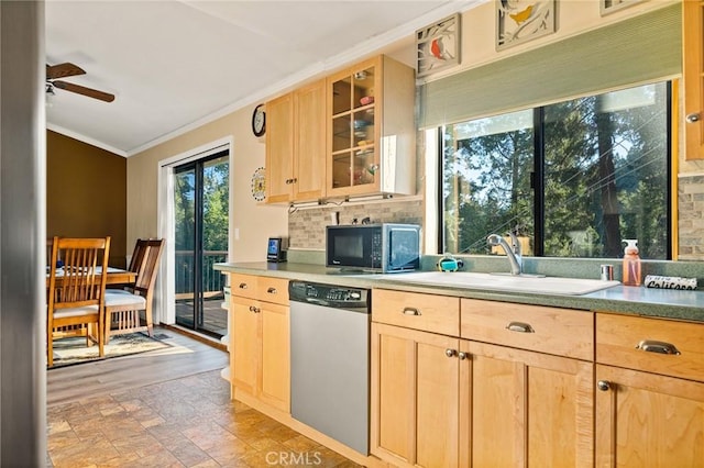 kitchen with stainless steel dishwasher, decorative backsplash, a sink, and light brown cabinets
