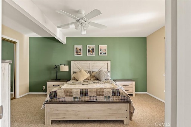 carpeted bedroom featuring beam ceiling, baseboards, and ceiling fan