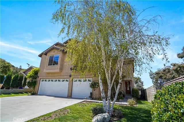 view of front of home featuring stucco siding, a front yard, fence, an attached garage, and concrete driveway