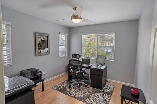 office area with baseboards, a ceiling fan, and wood finished floors