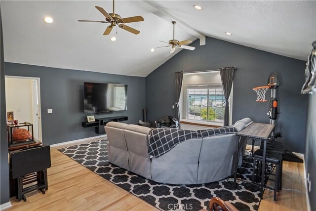 living area with wood finished floors, baseboards, a ceiling fan, and vaulted ceiling with beams