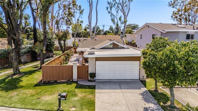 8292 Manifesto Cir, Huntington Beach, CA 92646 - view of front of house featuring an attached garage, concrete driveway, a front yard, and fence