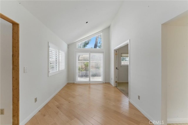 8292 Manifesto Cir, Huntington Beach, CA 92646 - unfurnished room with high vaulted ceiling, light wood-type flooring, and baseboards