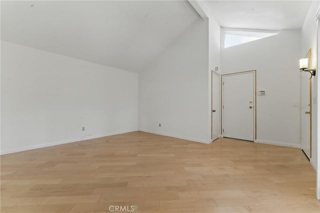 8292 Manifesto Cir, Huntington Beach, CA 92646 - additional living space featuring high vaulted ceiling, light wood-style floors, and baseboards