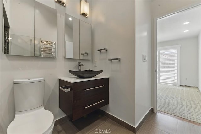 8292 Manifesto Cir, Huntington Beach, CA 92646 - bathroom featuring baseboards, toilet, recessed lighting, radiator, and vanity