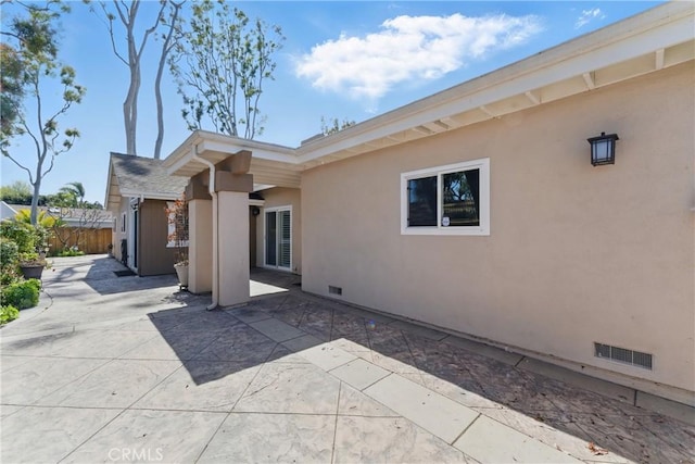 8292 Manifesto Cir, Huntington Beach, CA 92646 - rear view of property featuring visible vents, crawl space, fence, a patio, and stucco siding