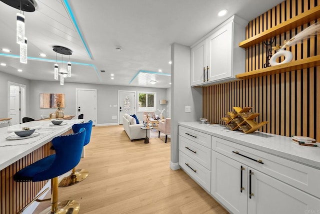 kitchen with open floor plan, white cabinetry, open shelves, recessed lighting, and light wood-style floors