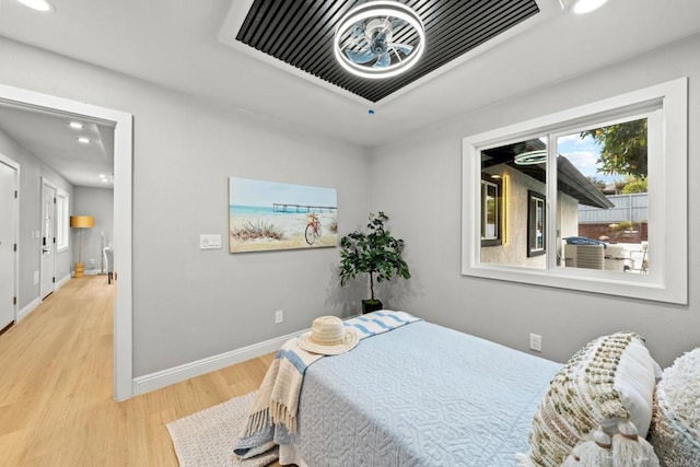 bedroom with recessed lighting, visible vents, baseboards, and wood finished floors