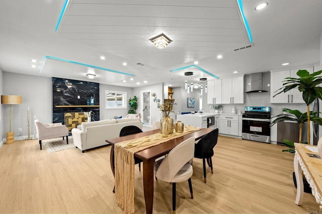 dining area featuring visible vents, light wood-style floors, and recessed lighting